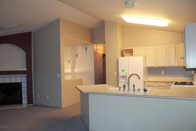 View of kitchen/ living area from dining