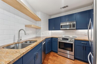 Kitchen featuring blue cabinets, light wood-type f