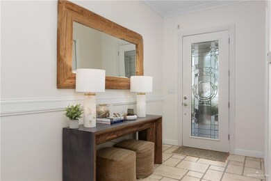 Foyer featuring ornamental molding and baseboards