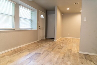 Entrance foyer with light wood-style flooring, baseboards, and recessed lighting