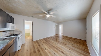 Kitchen featuring white appliances, visible vents,