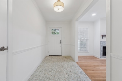 Well lit Front entry welcomes you with gorgeous and timeless Terrazo flooring and coat closet.