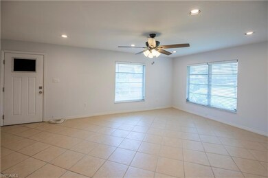 Spare room with a ceiling fan, plenty of natural light, recessed lighting, and light tile patterned flooring