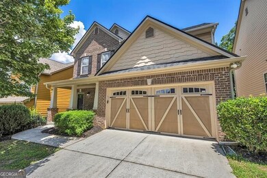 Craftsman-style house with driveway, an attached garage, brick siding, and a shingled roof