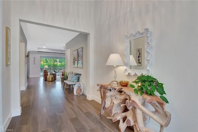 Corridor with baseboards and wood finished floors