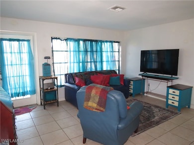 Living room featuring visible vents and tile patte