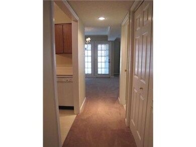 Hallway leads to kitchen and living room and featu