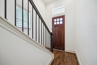 Entry with high ceilings, and hardwood flooring