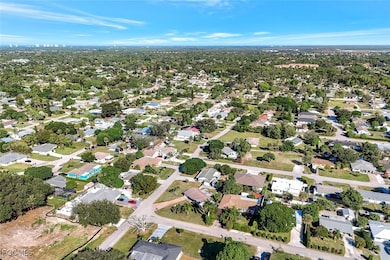 Aerial view of property and surrounding area featuring nearby suburban area
