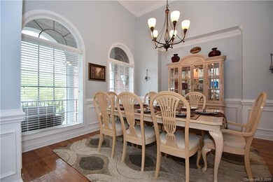 Dining Room located on the front of the home. Lots of natural light. Tall ceiling, wainscoting! Handsome chandelier!