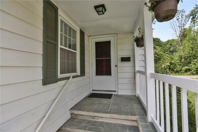 The front porch has a charming slate patio, and is