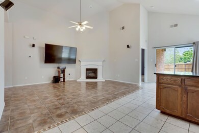 A Cast Stone Fireplace Anchors The Generously-Size