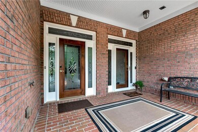 Property entrance featuring brick siding