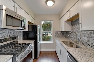 Kitchen featuring dark wood finished floors, a si