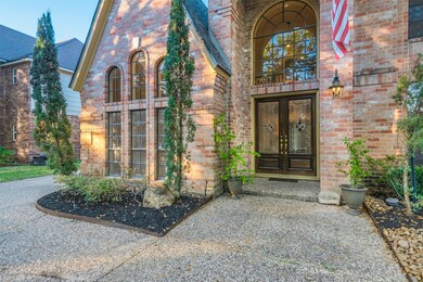 Impressive covered entry with double doors and lea