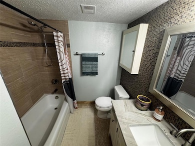 Full bathroom featuring shower / bath combo, a te