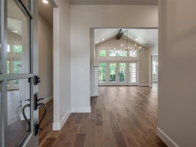 Hallway with high vaulted ceiling, beam ceiling, a
