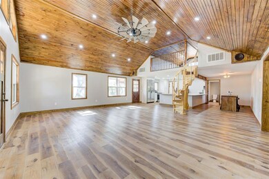 Unfurnished living room featuring high vaulted cei