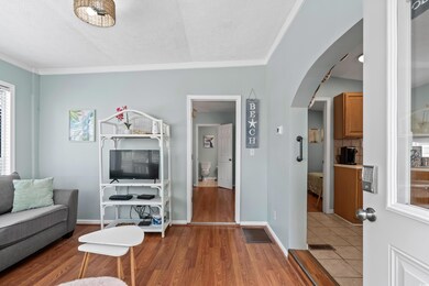 Living area with arched walkways, ornamental moldi