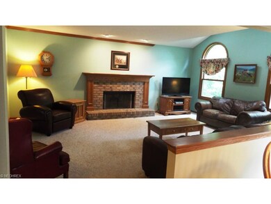 Family room is open to kitchen and has a fireplace, partially vaulted ceiling with skylights and French doors to dining room.