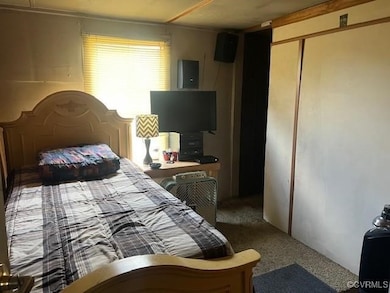 Bedroom with electric panel, a closet, and carpet floors