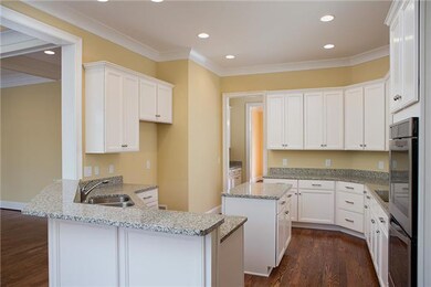 THE GOURMET KITCHEN IS LIGHT AND BRIGHT WITH A COOKTOP, DOUBLE OVENS, HARDWOOD FLOOR'S AND A GREAT WORK ISLAND. LOT'S OF RECESSED LIGHTING .