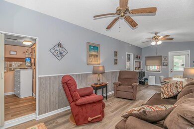 Living room with wood walls, vaulted ceiling, ceil