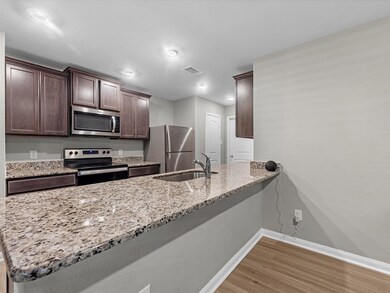 This kitchen has endless storage with plenty of countertop space and cabinets. Stainless steel appliances and fridge included. The buffet is perfect for hosting family and friends!