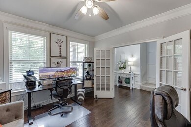 Office space with ornamental molding, a ceiling fan, french doors, and wood finished floors