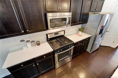 Stainless steel appliances including a gas stove.