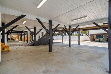 View of patio with fence and stairway