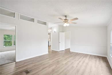 Spare room with a ceiling fan, wood finished floor