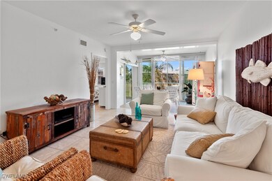 Living room featuring ceiling fan and light tile p
