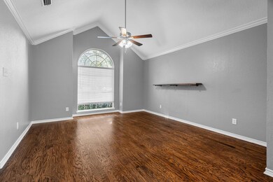 Empty room featuring ceiling fan, vaulted ceiling,