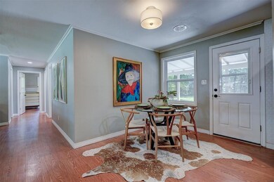 Dining area with crown molding and hardwood / wood