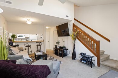 Living room featuring light carpet and ceiling fan