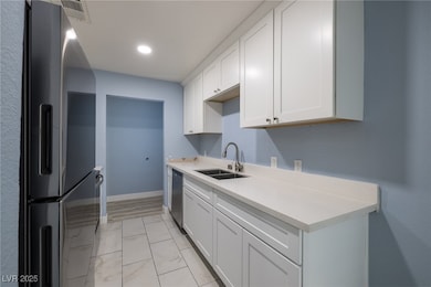 Kitchen includes stainless steel appliances white