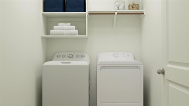 Laundry area featuring washing machine and clothes