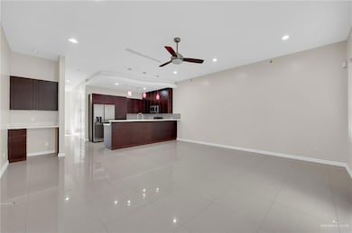 Unfurnished living room featuring a ceiling fan, recessed lighting, and light tile patterned floors