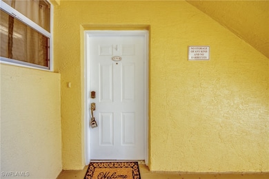 Doorway to property with stucco siding