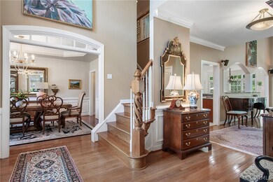 Foyer with ornamental molding, an inviting chandel