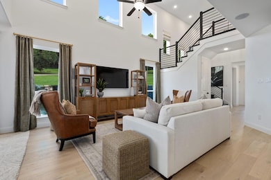 Living room featuring a high ceiling and a wealth 