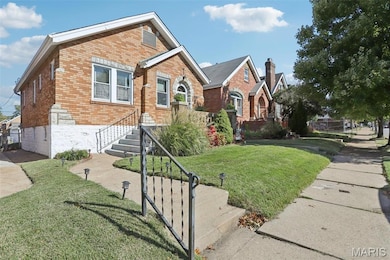 View of front of house with brick siding and a front yard