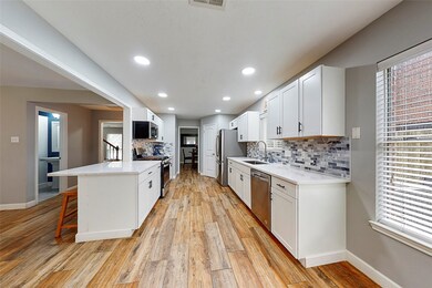 Kitchen has lots of counter space, breakfast bar and opens to the family room.