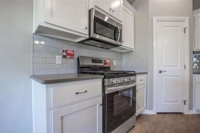 Kitchen featuring white cabinets, stainless steel 