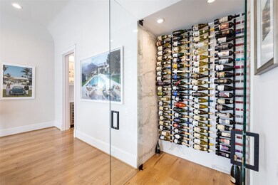 The dining room features a room-temp wine cellar encased by custom glass doors and racks capable of holding over 80 bottles.