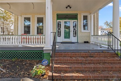 View of exterior entry with covered porch