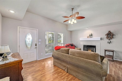 Living area with light wood-style flooring, baseb