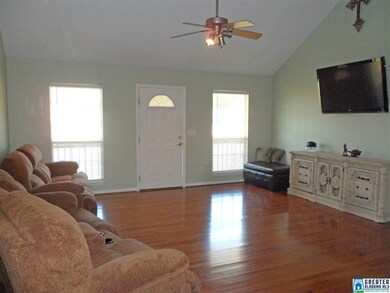 The living room has tall vaulted ceilings giving t