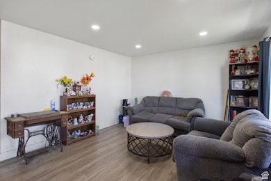 Living room with wood finished floors and recessed lighting